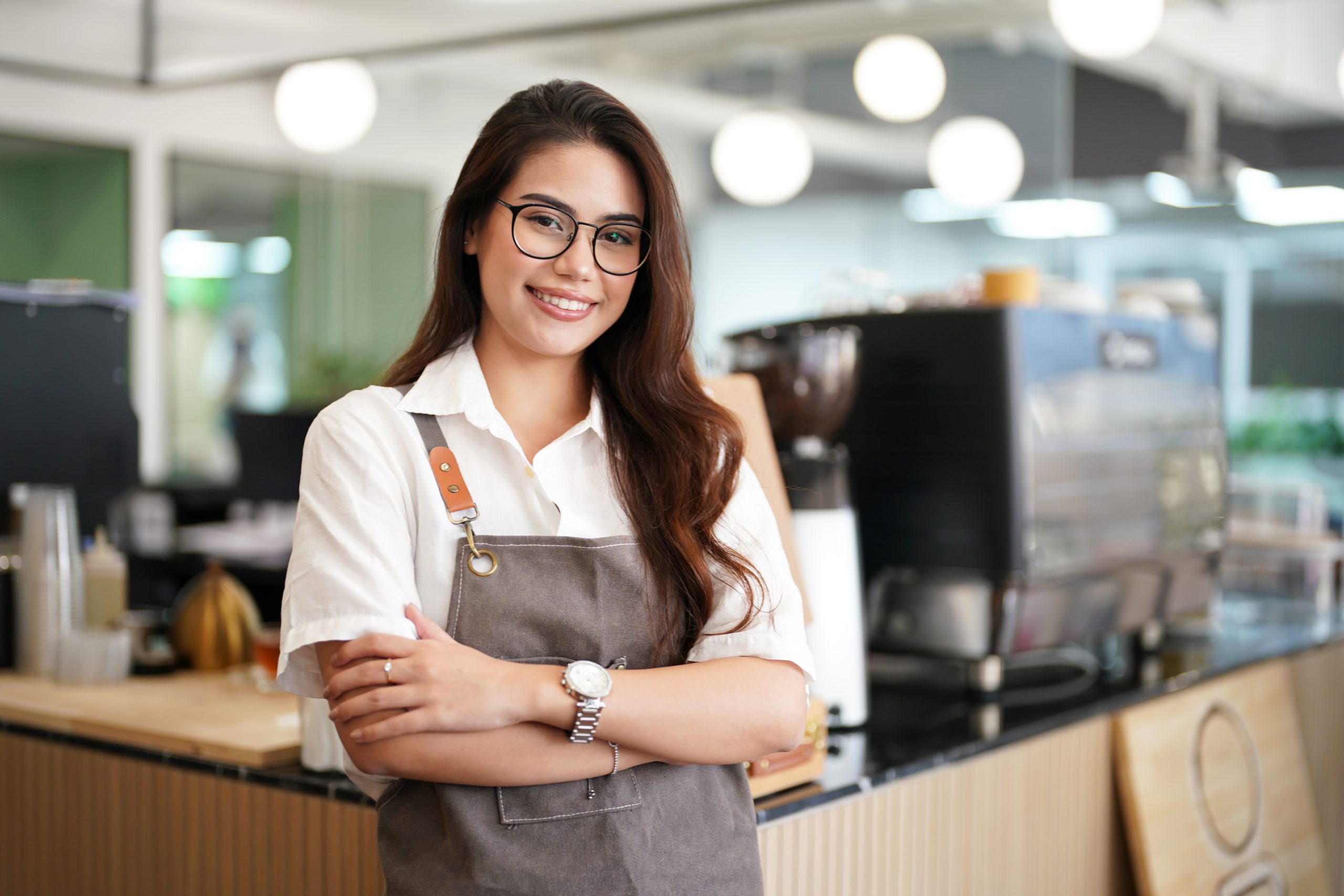 Portrait Of A Happy Waitress Standing At Restaurant Entrance, Coffee Shop,. Business Owner. - Recuperação de Impostos | Planrec Gestão Tributária